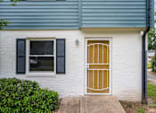 Thumbnail 3 of 16 - the front door of a white house with a gold door