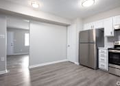 Thumbnail 9 of 16 - an empty kitchen with stainless steel appliances and white cabinets