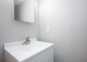 Thumbnail 13 of 16 - a white bathroom with a sink and a mirror