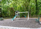 Thumbnail 6 of 16 - a playground with a swing set and a slide