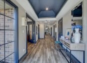 Thumbnail 4 of 43 - a hallway with a blue ceiling and wood flooring