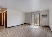 Thumbnail 31 of 47 - a bedroom with hardwood floors and white walls
