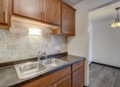 Thumbnail 17 of 47 - a kitchen with wood cabinets and a sink