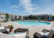 Thumbnail 21 of 43 - A pool surrounded by chairs and umbrellas.