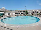 Thumbnail 20 of 43 - A large swimming pool in front of apartment buildings.
