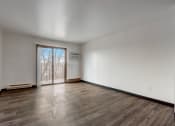 Thumbnail 21 of 47 - a bedroom with hardwood floors and white walls