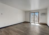 Thumbnail 20 of 47 - a bedroom with hardwood floors and white walls
