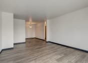 Thumbnail 22 of 47 - a bedroom with hardwood floors and white walls