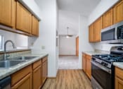 Thumbnail 38 of 60 - a kitchen with wooden cabinets and stainless steel appliances