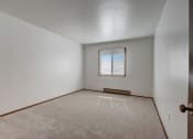 Thumbnail 26 of 47 - a bedroom with white walls and carpet