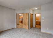 Thumbnail 38 of 64 - an empty living room with a door to a bedroom and a bathroom