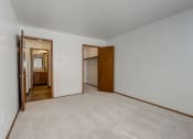Thumbnail 25 of 47 - a bedroom with a carpeted floor and an open door to a bathroom