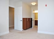 Thumbnail 19 of 31 - A white door is in a room with a brown cabinet.