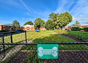 Thumbnail 3 of 27 - A sign that says "Welcome to Our Dog Park" is in front of a fence.