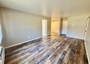 Thumbnail 23 of 27 - A room with wooden flooring and white walls.