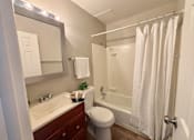 Thumbnail 27 of 27 - A white bathroom with a toilet, sink, and shower.