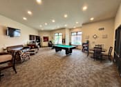 Thumbnail 4 of 34 - A spacious living room with a pool table and comfortable seating.