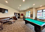 Thumbnail 3 of 34 - A room with a pool table and a couch.