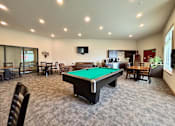 Thumbnail 2 of 34 - A room with a pool table and chairs.