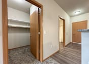 Thumbnail 26 of 34 - A room with a wooden door and a grey carpet.