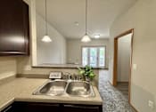 Thumbnail 23 of 34 - A kitchen with a sink and a sign that says "worth".