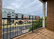 Thumbnail 33 of 34 - A view of a street from a balcony with a black railing.