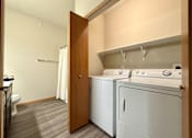 Thumbnail 32 of 34 - A laundry room with a washer and dryer.