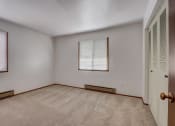 Thumbnail 36 of 47 - a bedroom with two windows and a door