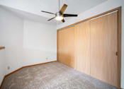 Thumbnail 49 of 60 - an empty room with a ceiling fan and a closet