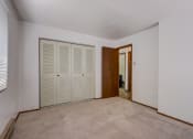 Thumbnail 37 of 47 - a bedroom with two closets and a carpeted floor
