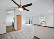 Thumbnail 41 of 60 - a living room with white walls and a ceiling fan