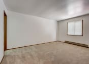 Thumbnail 41 of 47 - a bedroom with white walls and carpet