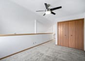 Thumbnail 35 of 60 - a living room with white walls and a ceiling fan