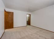 Thumbnail 43 of 47 - a bedroom with white walls and a wooden door