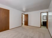 Thumbnail 39 of 47 - a bedroom with white walls and a carpeted floor