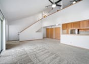 Thumbnail 34 of 60 - an empty living room with white walls and a ceiling fan