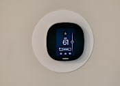 Thumbnail 37 of 75 - a digital thermostat on a white wall