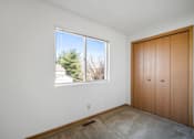 Thumbnail 37 of 60 - a bedroom with a large window and a closet