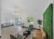 Thumbnail 14 of 60 - a living room with a couch and chairs and a green wall