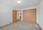 Thumbnail 8 of 60 - a living room with a carpeted floor and a door to a hallway with a