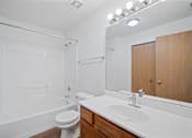 Thumbnail 12 of 60 - a bathroom with a sink toilet and shower and a mirror