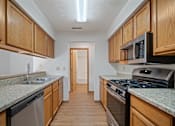 Thumbnail 1 of 60 - a kitchen with granite counter tops and wooden cabinets