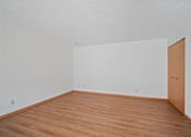 Thumbnail 7 of 60 - an empty room with wood floors and white walls