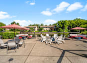 Thumbnail 24 of 60 - a patio with tables and chairs and umbrellas