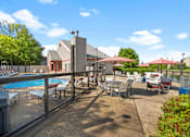 Thumbnail 26 of 60 - a swimming pool with tables and chairs at a resort