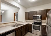 Thumbnail 18 of 102 - a kitchen with a stove and a refrigerator