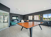 Thumbnail 20 of 60 - a games room with a ping pong table and a tv