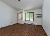 Thumbnail 5 of 19 - an empty living room with wood flooring and a window