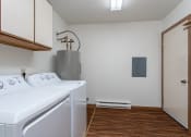 Thumbnail 16 of 19 - the laundry room has a washer and dryer and a door to the closet