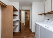 Thumbnail 12 of 19 - a laundry room with a washer and dryer and a hall to a bathroom